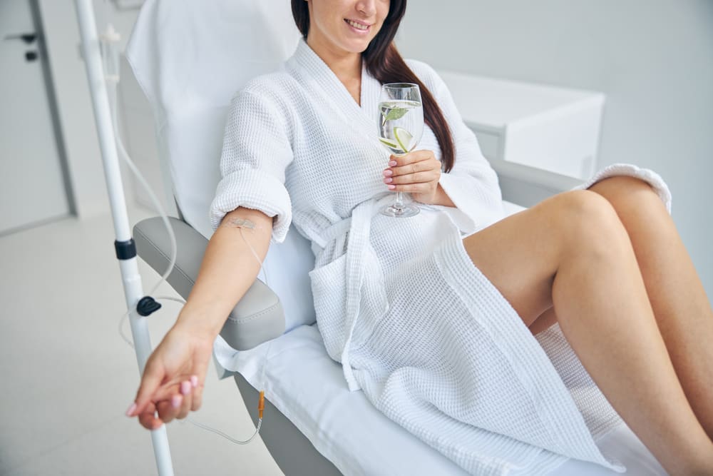 Cropped photo of a patient with a catheter in her vein undergoing the medical procedure